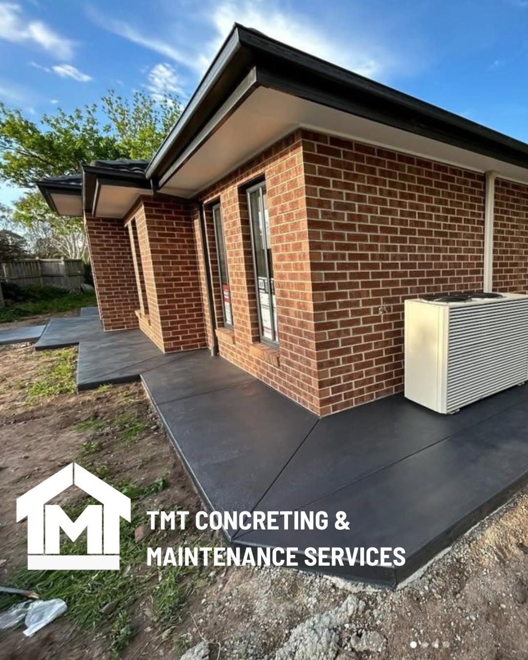 Coloured concrete path running alongside a brick home, Sale