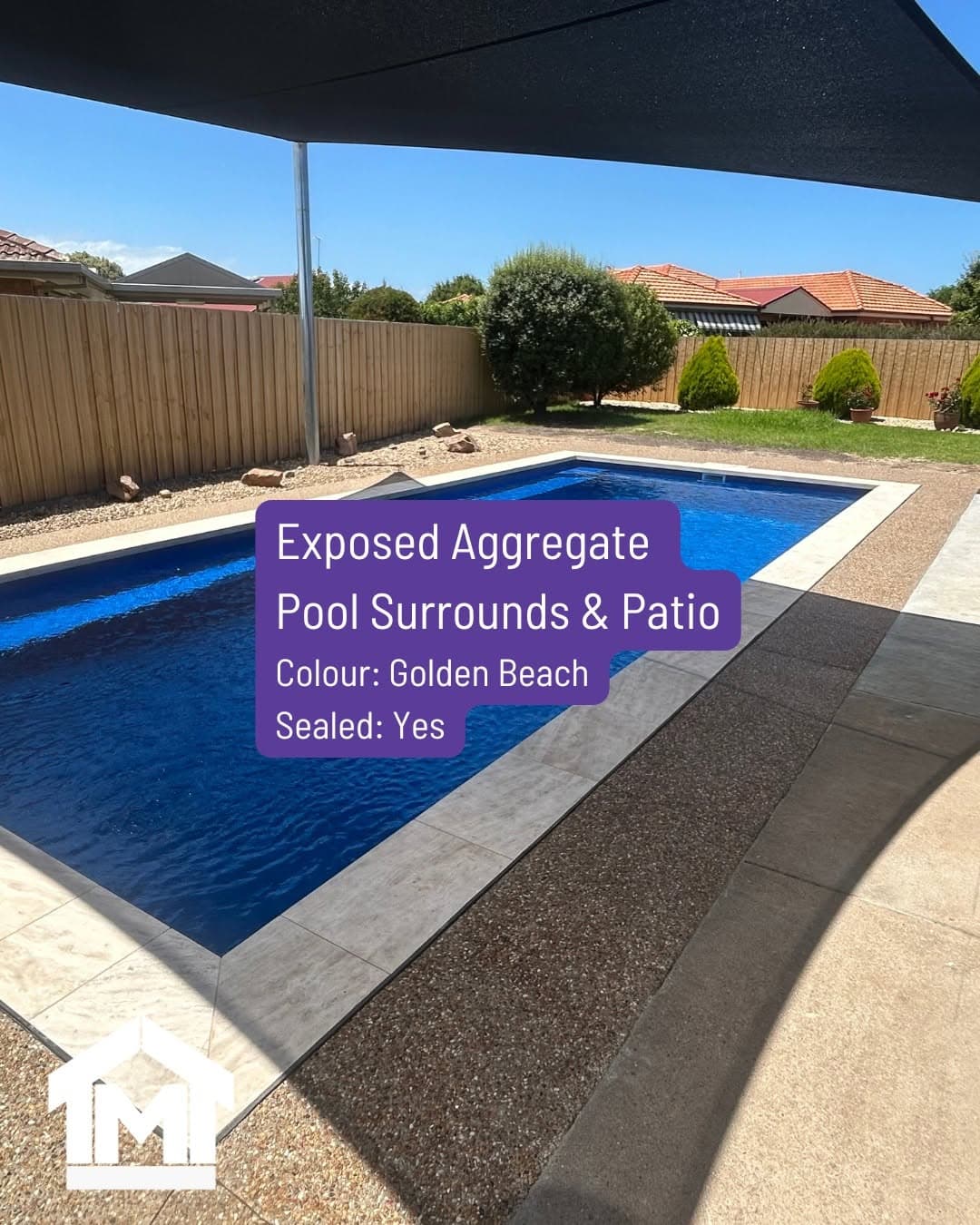 Exposed-aggregate pool surround and patio in a Golden Beach finish beside a fibreglass pool, Sale