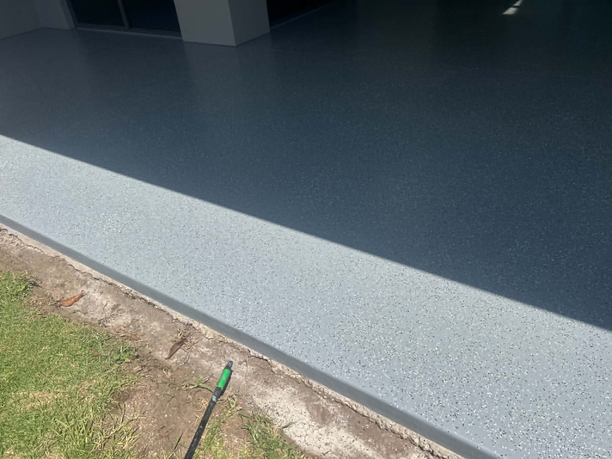 Charcoal flake epoxy garage floor with lighter grey apron extending out to lawn, Traralgon