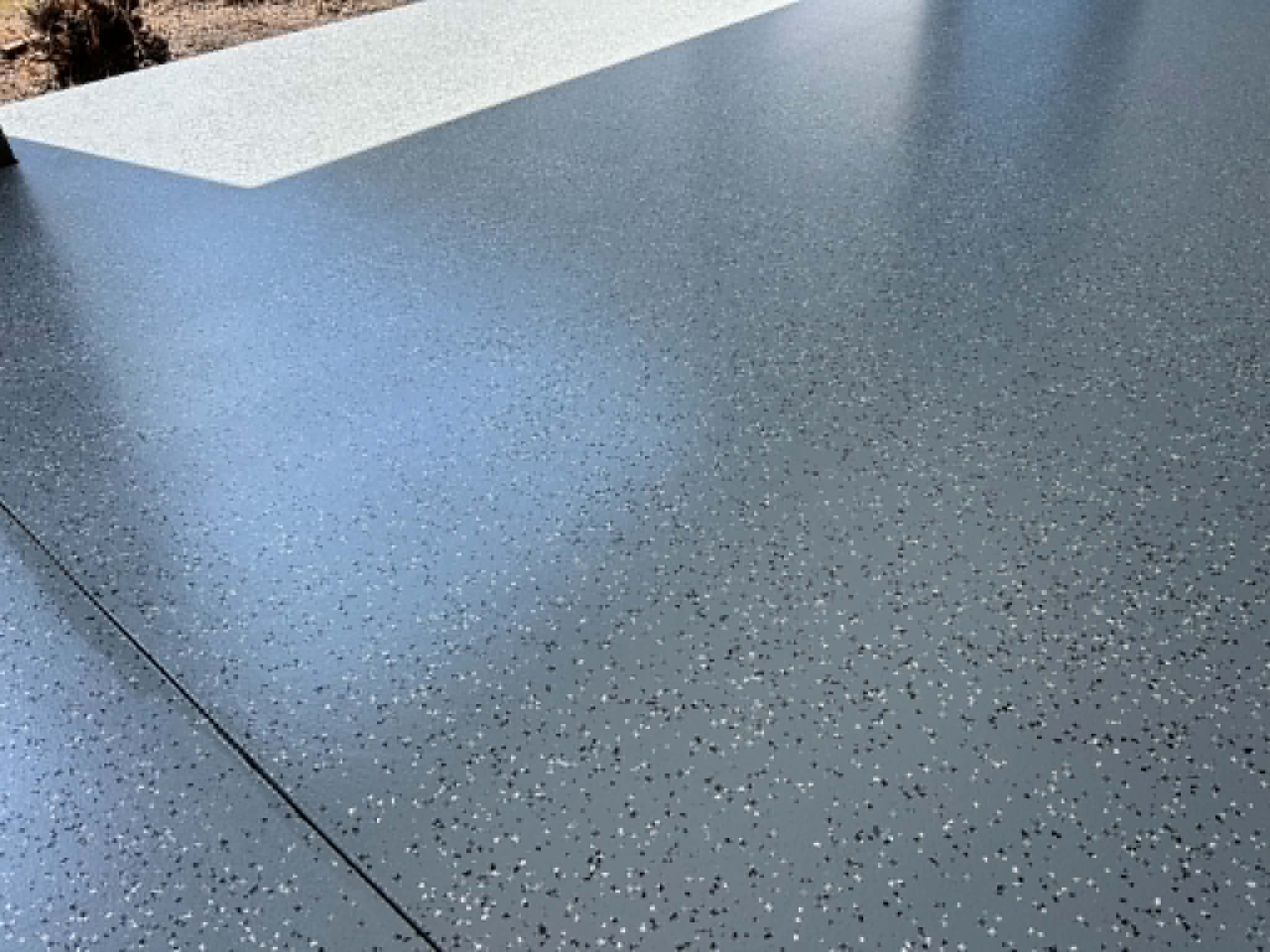 Charcoal flake epoxy garage floor edge meeting white concrete step, Traralgon