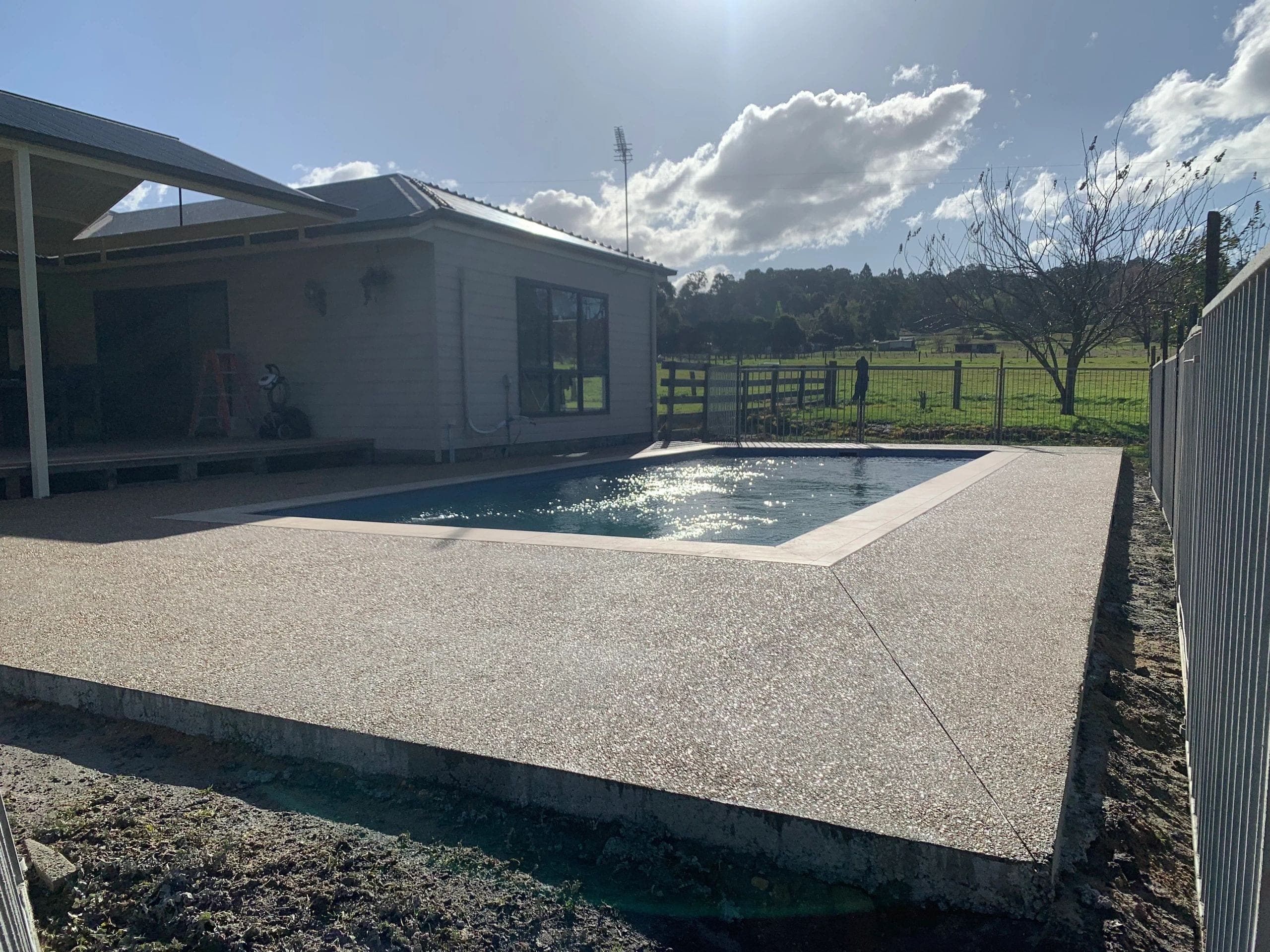 Exposed aggregate pool surrounds · Golden Beach · TMT Concreting & Maintenance