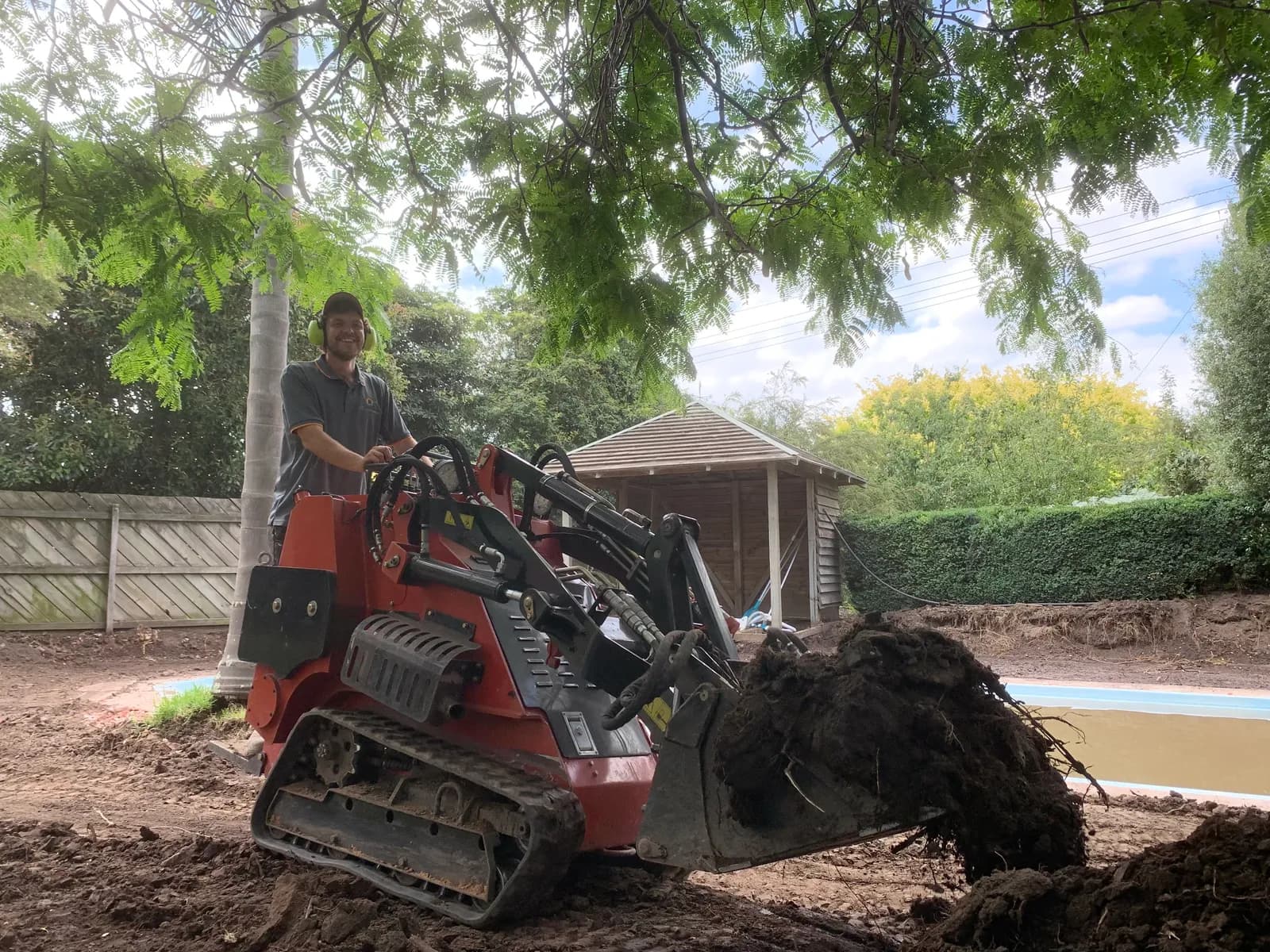 Ray from TMT Concreting operating a mini-loader during site prep on a Gippsland job